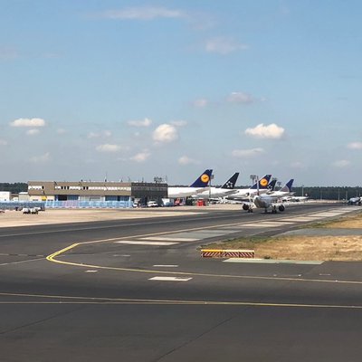 Flugfeld mit geparkten Maschinen am Rand