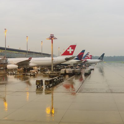 Flughafen Zürich: Rollfeld mit mehreren parkenden Jets im regen